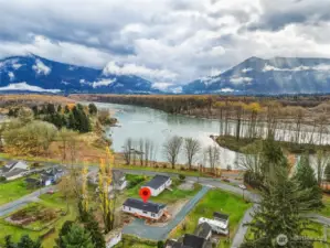 Stunning natural beauty surrounds the home--river, mountain, sky.