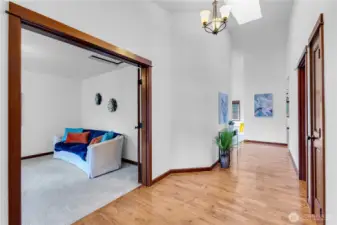 Entry with tall ceiling and large office/bonus space to the left