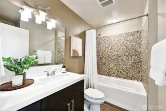 Full bathroom with tile surround and Quartz counters