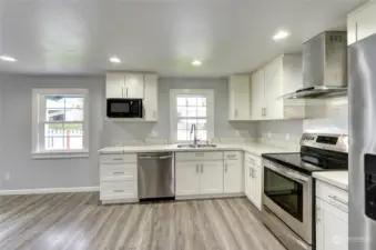 All new open concept kitchen includes new plumbing throughout the home. (Refrigerator and microwave do not convey.)