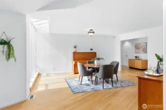 The great room gives way to dining area, flooded with light.