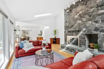 Light-filled great room with floor-to-ceiling stone fireplace.