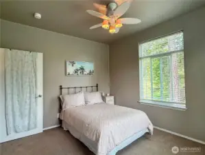 Bedroom two bright and sunny with large picture windows.