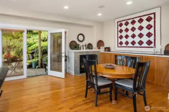 informal dining area with gas fireplace and French doors to covered outdoor patio