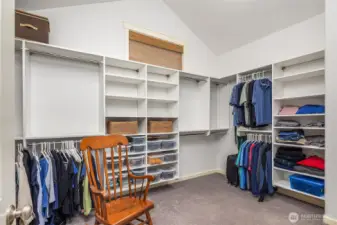 Expansive walk in closet with custom California Closets