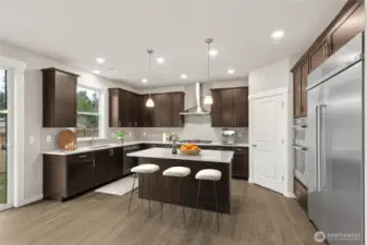 Virtually staged, well-appointed kitchen with gas cooktop & 48" side by side counter depth built in refrigerator.