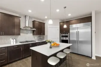 Virtually staged, gas cooktop + 48" side by side counter depth built in refrigerator.  Kitchen opens to great room and formal dining - great space to host gatherings!