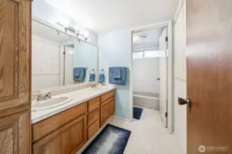 Main bath has dual sinks and extra storage space.