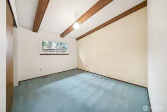 3rd bedroom. Love the exposed beams and the cool retro lighting!