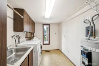 Laundry Room has lots of storage space, a utility sink, and the nice washer and dryer stays.
