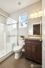 Bright 3/4 bathroom with modern fixtures right next to the main floor bedroom/office.