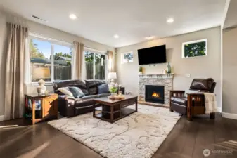 A cozy stacked brick fireplace centerpiece makes this living room perfect