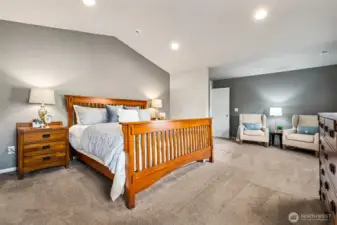 Expansive primary bedroom with vaulted ceilings and a relaxing, airy feel.