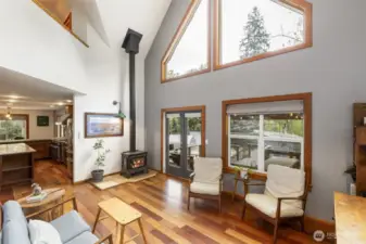 Toasty free-standing wood stove. Living room flows to the kitchen.
