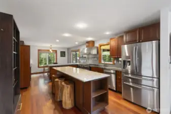 Stunning kitchen with granite and concrete counters, Stainless Steel appliances, propane gas range.