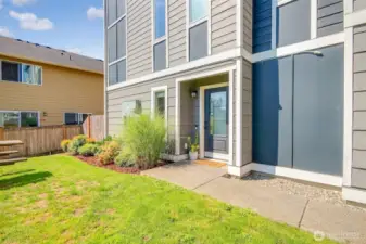 Private side entrance that borders green space.