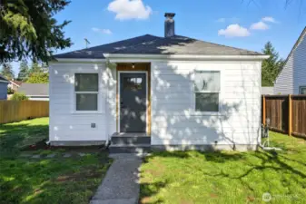 Front of the home with cedar detailing at the entry,