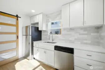 Barn door leads to utility room.