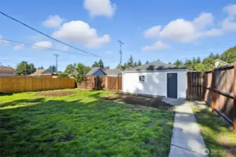 Looking from the home to the garage. Property is fully fenced.