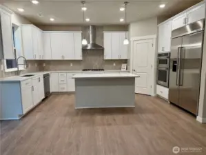 Home for sale includes built in refrigerator, gas cooktop - a great space to gather!