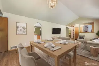 GRACEFUL LIVING ROOM WITH EASY ACCESS TO KITCHEN AND DINING AREA.