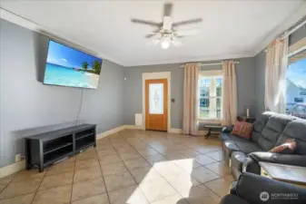 Spacious Livingroom with ceramic tile flooring and high ceilings.