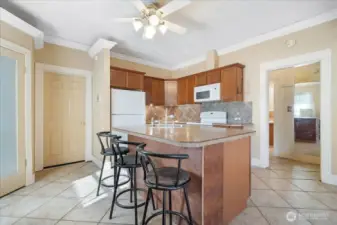 Oversized island in the kitchen with eating space. Close to the cozy pellet stove and large pantry.