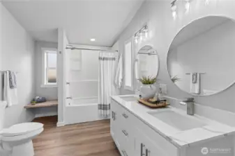 Primary Bathroom. New lights, fixtures, tub, toilet. Sitting bench