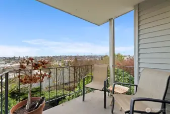 Covered balcony bliss—sip, unwind, and soak up the skyline from your private outdoor retreat.