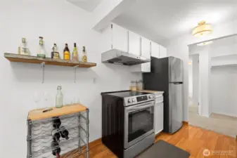 A chic kitchen moment with open shelving, stainless appliances, and space to showcase your favorite bottles.