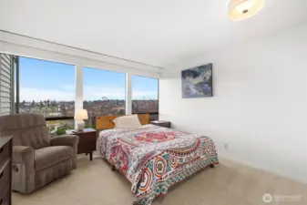 Wake up to skyline vistas and soft morning light in this inviting bedroom sanctuary.