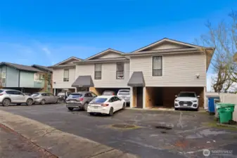 Community perspective showcasing the condo setting and shared entrance within a welcoming residential environment.