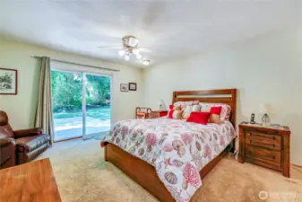 The primary bedroom with access to the back patio through the sliding glass doors.