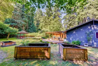 Raised beds, a gazebo and multiple decks all make this a space full of possibilities.