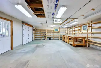 Inside the single-car garage and workshop with extensive storage shelving all around.