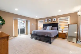 Huge primary suite with slider leading to a covered deck.