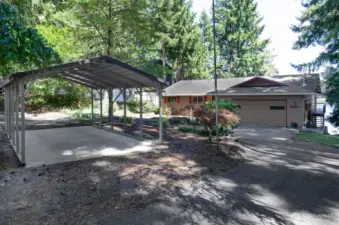 The front view from Long Lake Dr. showcases the carport , driveway and garage for plenty parking