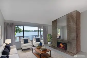 Main living room area with cool views. The functioning wood burning fireplace adds warmth on those cold days.
