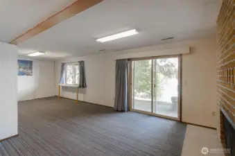 Basement without the furnishings. The sliding glass door leads you to an outdoor patio.