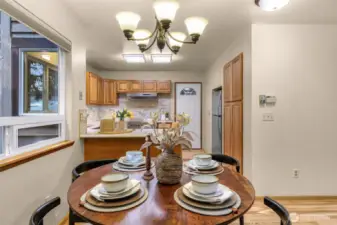 Cozy and intimate, the dining nook is perfect for everyday meals or evening dinners under soft pendant lighting. The window frames the natural beauty just outside.