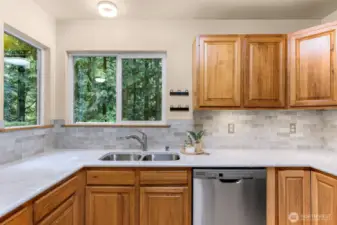 Nestled between corner windows, the deep stainless sink offers a serene view of the forest canopy. Every dish comes with a dose of peaceful nature.