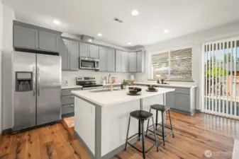 Gourmet kitchen with gorgeous island, quartz countertops, beutiful cabinetry and stainless steel appliances