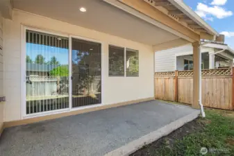 The large covered porch is great for outdoor seating and storing your BBQ grill