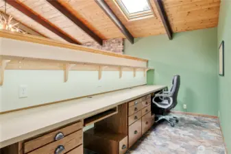 Office area for multiple computer stations, filing cabinets and skylights