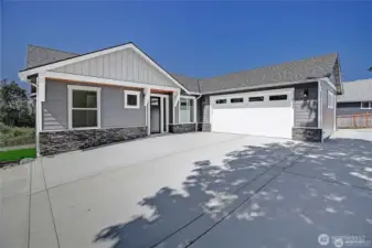 Large two car garage with ample parking and extra space next to the garage.