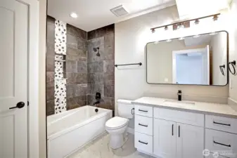 Guest bathroom with custom tiled shower.