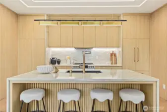 The oversized island provides generous seating for casual dining and interactive meal prep.
