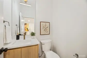 half-bath featuring modern floating vanity and designer fixtures.