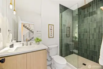 Contemporary guest bathroom featuring sleek hardware and a stylish walk-in shower.