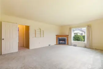 The large living room is light and bright...note the curved ceilings and built in shelves...